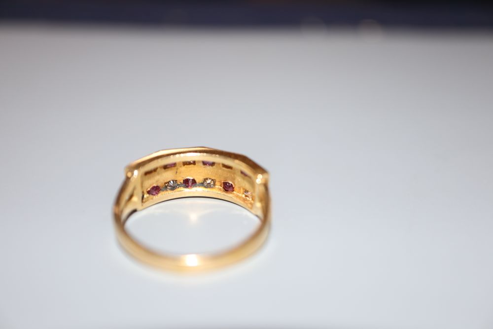 A modern 18ct, eight stone ruby and eight stone diamond set half hoop dress ring, size L/M, gross 3.7 grams.